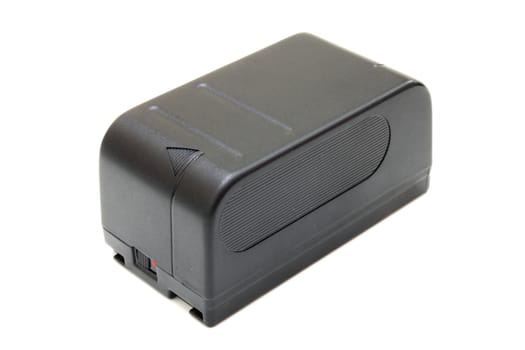 The black small rectangular accumulator from a videocamera on a white background
