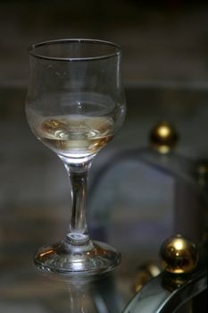 Wine glass with a wine on a transparent table