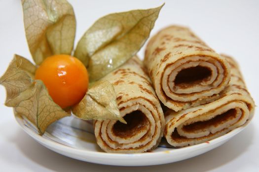 Pancakes on a plate and yellow berry