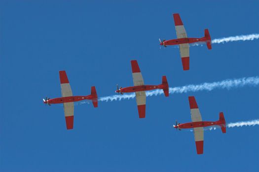 Four Prop planes flying in formation at an airshow