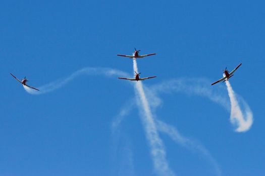Four Prop planes performing at an airshow