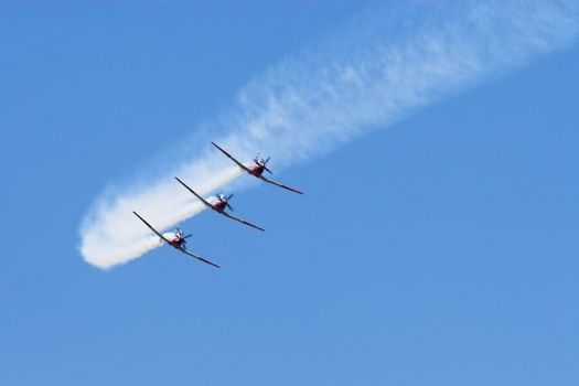 Three prop planes performing at an airshow
