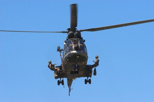 Soldiers practicing attack exercises from a helicopter