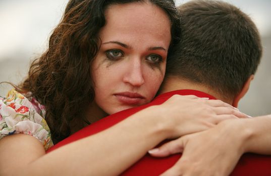 The crying girl embraces the man