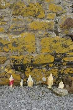 religious stauettes against a wall