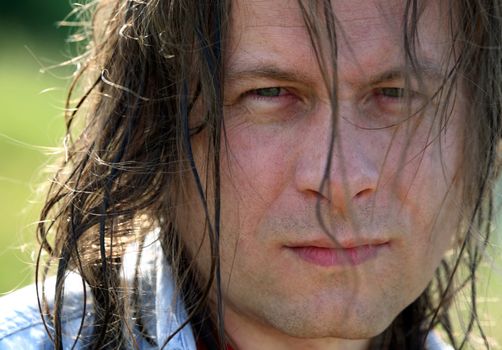 Portrait of the man with wet hair close-up