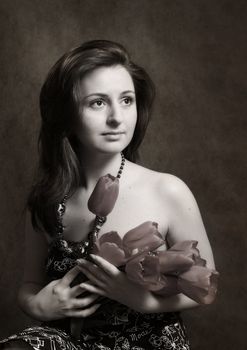 The image of the beautiful girl with tulips in hands