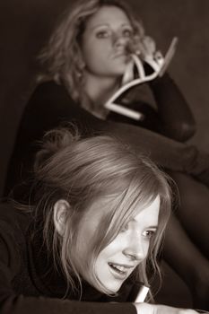 Two girls with shoes in studio