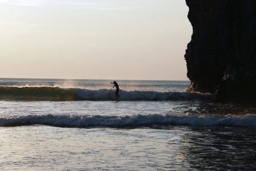 lone surfer against irish cliffs