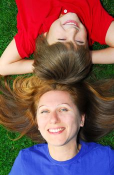 Portrait of smiling mother and son in summer park