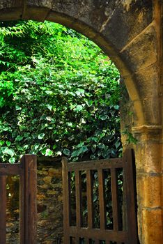 Garden gate in medieval town of Sarlat, Dordogne region, France