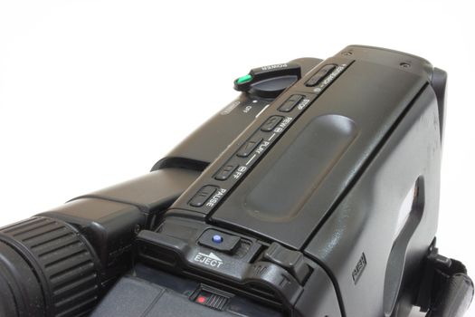 Black videocamera with buttons and switches on a white background
