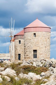 Medieval windmills at Mandraki Harbour in the Dodecanese island of Rhodes, Greece.