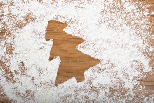Gingerbread cookies shape on a table full of flour