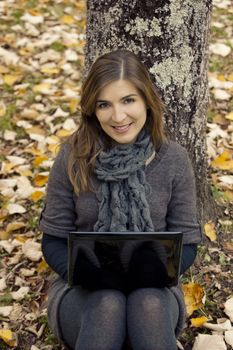 Beautiful woman working with a laptop in outdoor