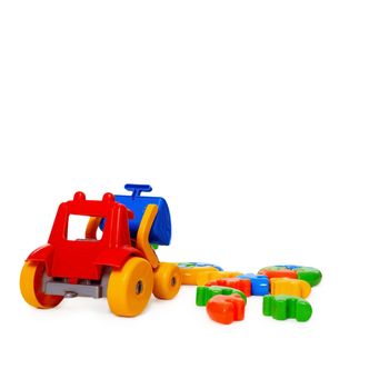 Color plastic toy bulldozer isolated on white background