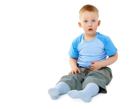 Surprised a little boy sitting isolated on white background