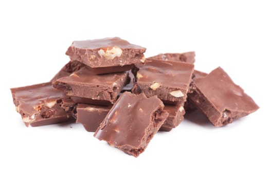 Pile of chocolate chunks isolated against a white background