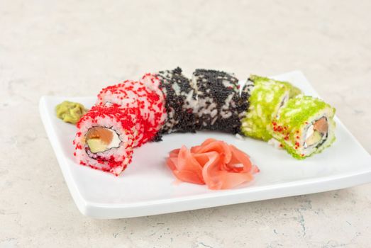 Sushi rolls made of salmon, avocado, flying fish roe - tobiko caviar and philadelphia cheese