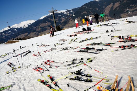 KAPRUN AUSTRIA - MARCH 5: Maiskogel Fanlauf 2011. Many pairs of ski at the target area of charity ski race with many celebrities in austria on March 5, 2011 at the Maiskogel in Kaprun, Austria