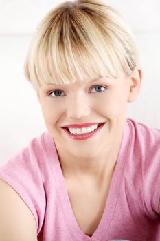 Young smiling woman at home.