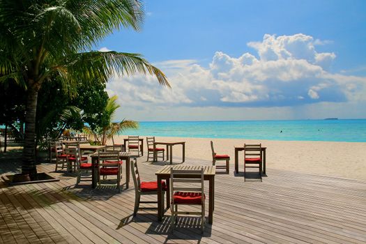 Restaurant and turquoise water on Meeru Island, Maldives