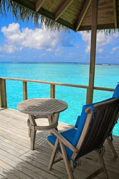 Water villa and turquoise water on Meeru Island, Maldives