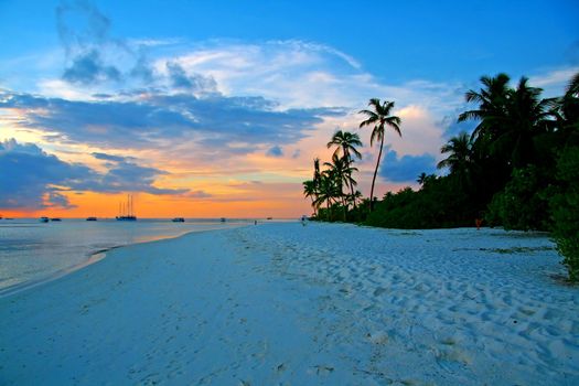 Evening pictures of the beach and boats on Meeru Island, Maldives