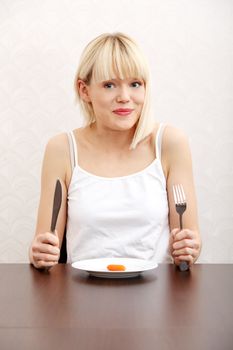 Beautiful woman eating carrot .