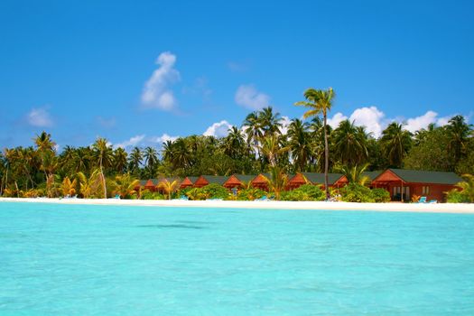 Water villas and turquoise water on Meeru Island, Maldives