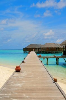 Water villas and turquoise water on Meeru Island, Maldives