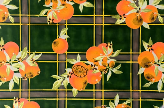 Beautiful orange fruit drawing on the table curtains. Decorative background.