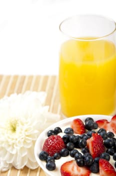 light Breakfast: orange juice, croissants and Berries on a table