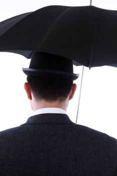 man with bowler hat and an umbrella in the back