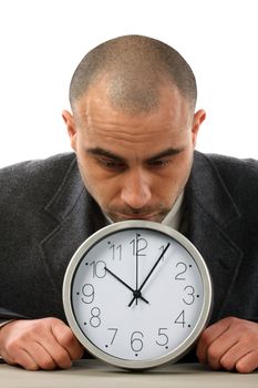 Businessman holding a big clock. Time for work concept 