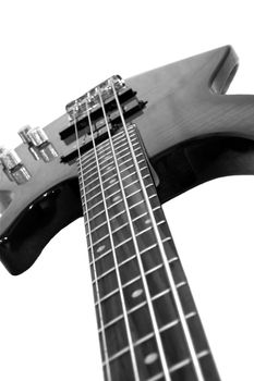 Closeup of a bass guitar isolated on white