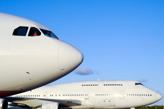 Two jumbo jet planes in an airport. 