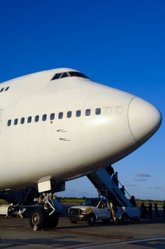 Air travel - A parked plane is loading off Passengers in an airport