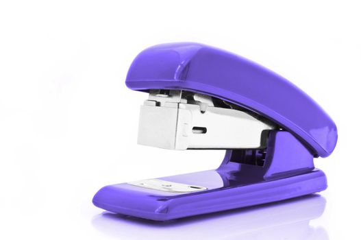 Close up of a single purple office stapler isolated over white