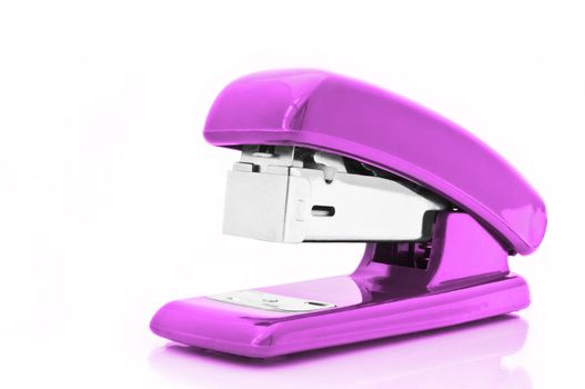 Close up of a single pink office stapler isolated over white