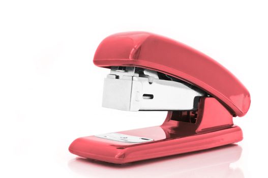 Close up of a single red office stapler isolated over white
