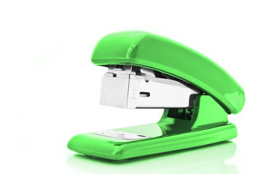 Close up of a single green office stapler isolated over white