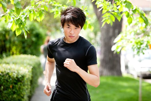 Portrait of a handsome serious man jogging in a park