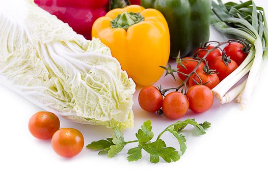Cabbage with cherry tomatoes, lettuce and pepper isolated on white background