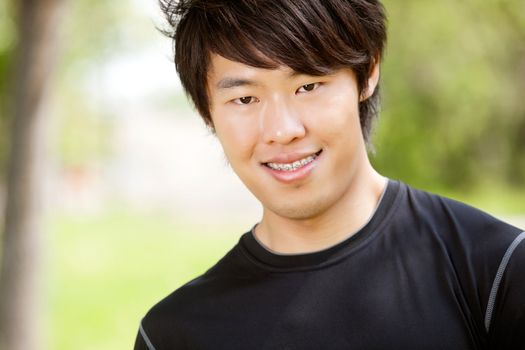 Portrait of a man smiling against blur background