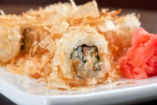 Sushi rolls of rice, nori, cream cheese, avocado, smoked salmon,cucumber and cuts of tuna