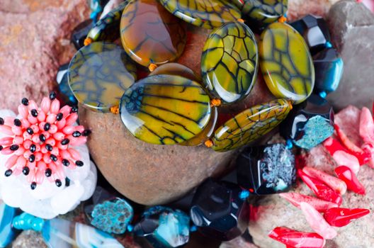 Close up of many different colorful natural gems: agate onyx, coral