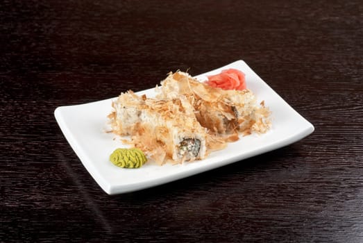 Sushi rolls of rice, nori, cream cheese, avocado, smoked salmon,cucumber and cuts of tuna
