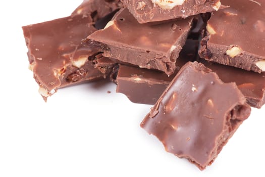 Pile of chocolate chunks isolated against a white background