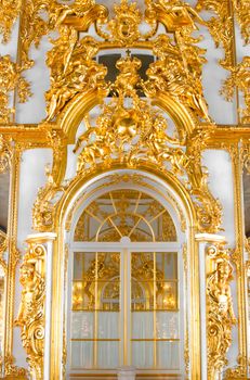 beautiful wall with large door, golden candelabras and decorations in Catherine Palace